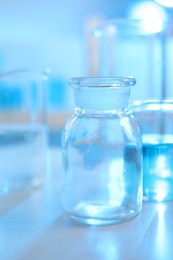 Photo of Laboratory glassware with liquid on table indoors