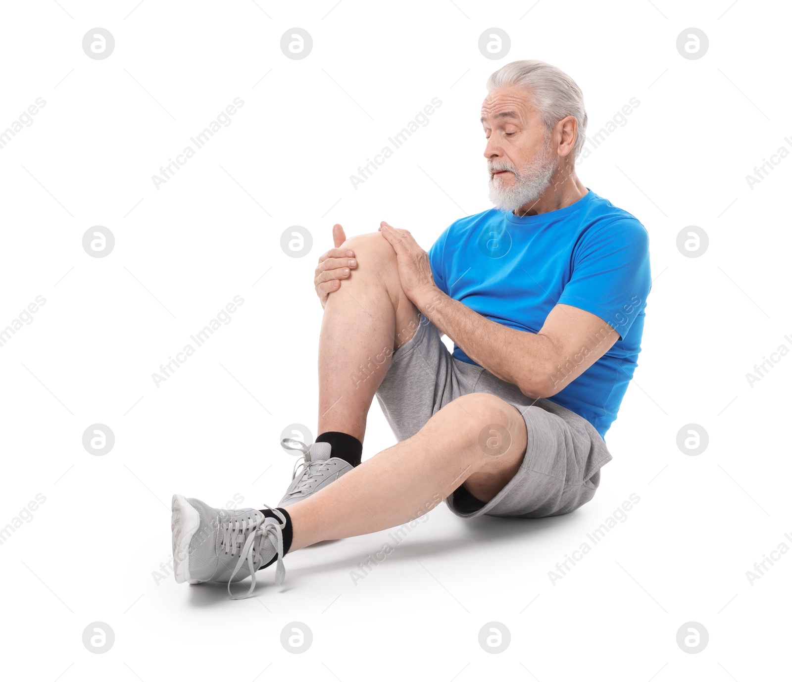 Photo of Senior man suffering from knee pain on white background