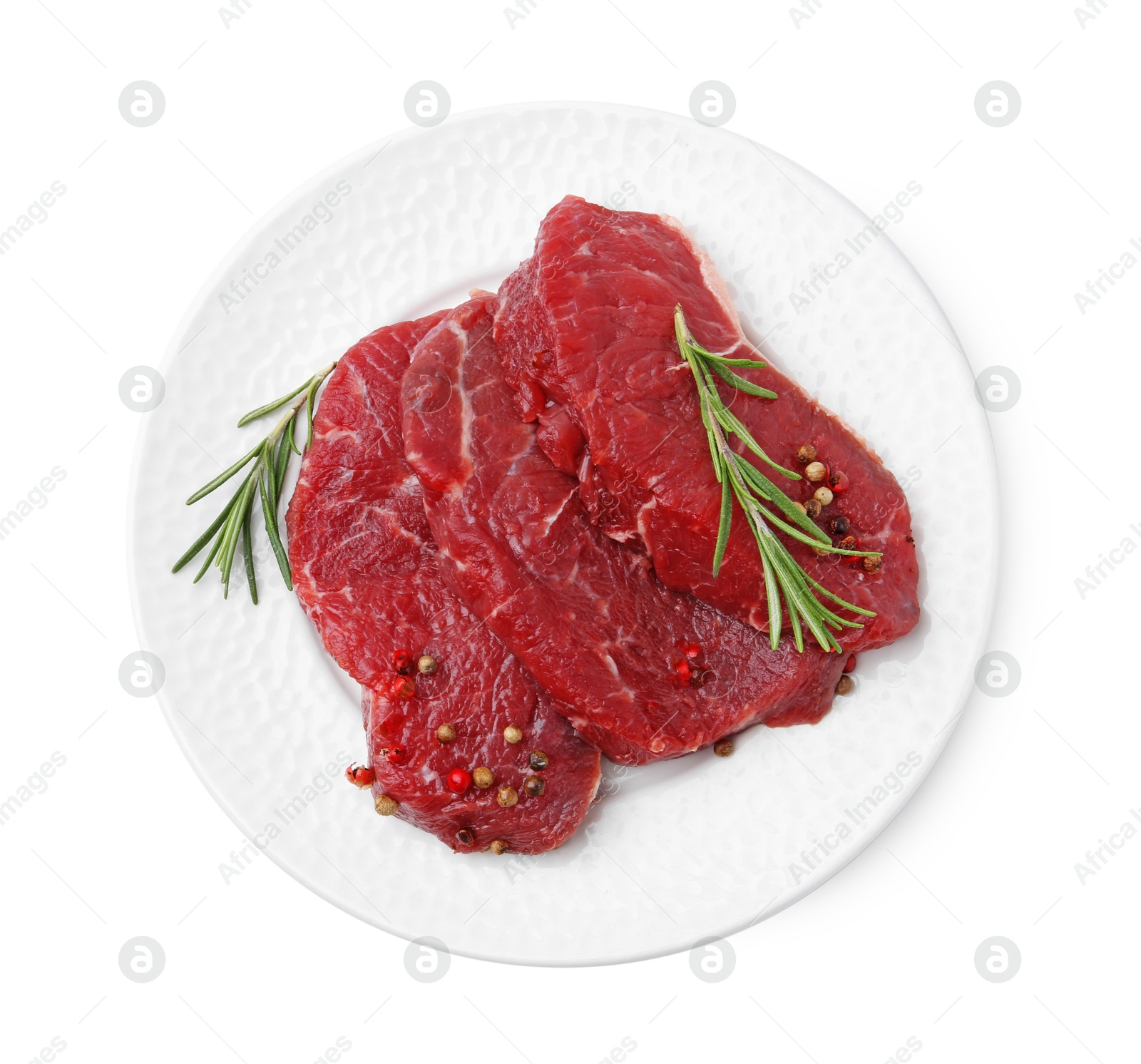 Photo of Pieces of raw beef meat and spices isolated on white, top view