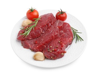 Photo of Pieces of raw beef meat, spices and tomatoes isolated on white