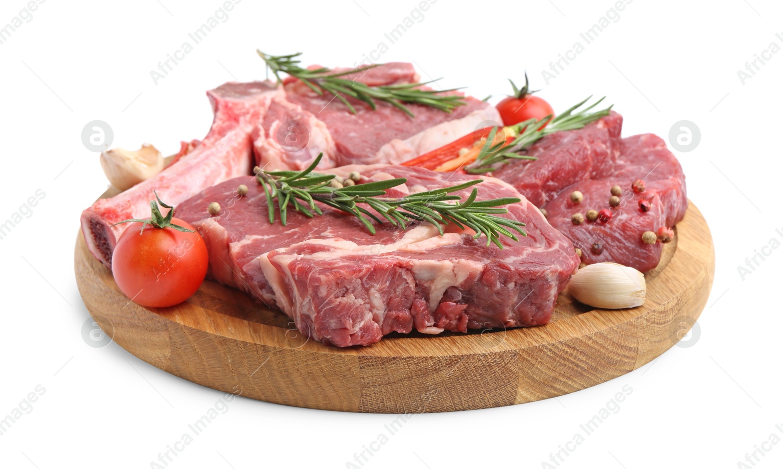 Photo of Pieces of raw beef meat, spices and tomatoes isolated on white