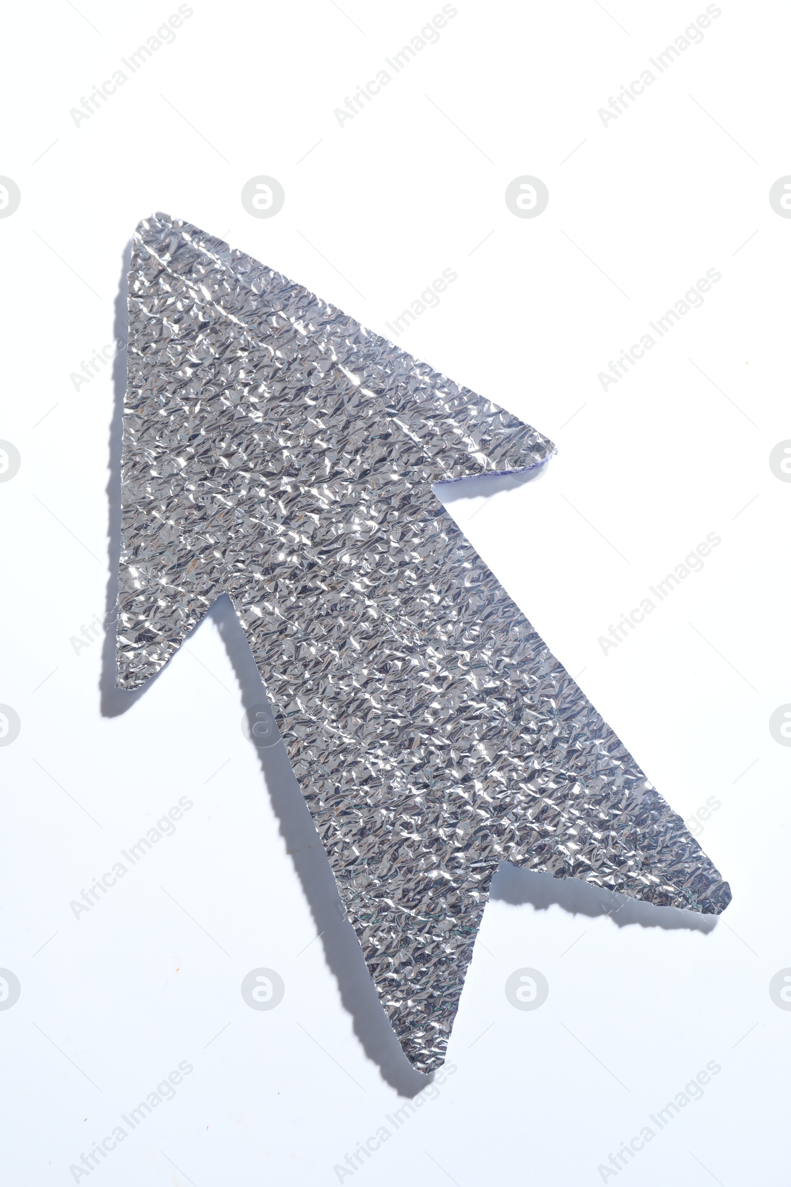 Photo of Silver tinfoil arrow on white background, top view