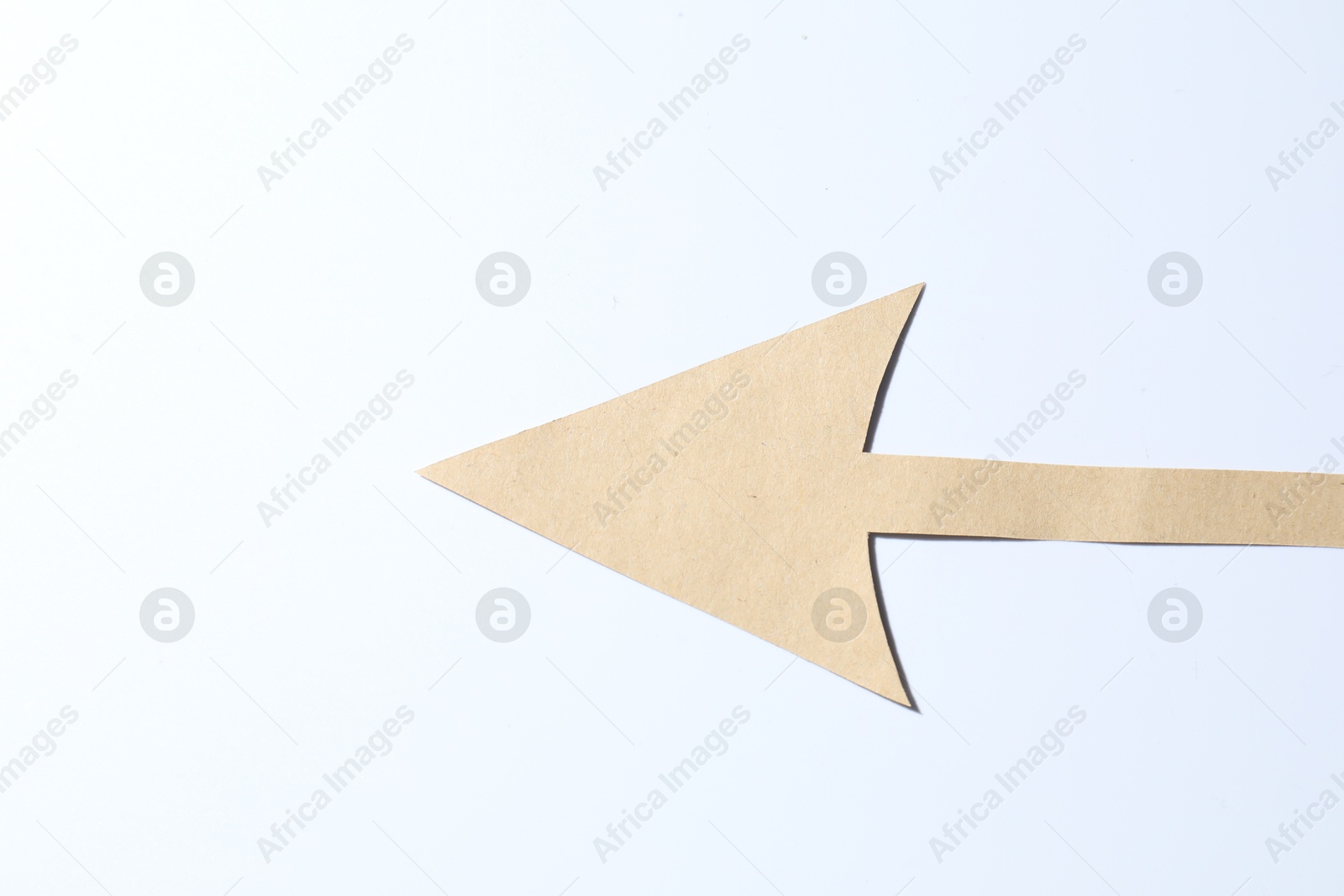 Photo of One kraft paper arrow on white background, top view. Space for text