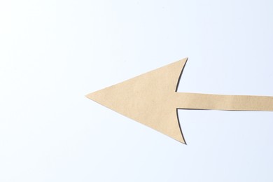 Photo of One kraft paper arrow on white background, top view. Space for text