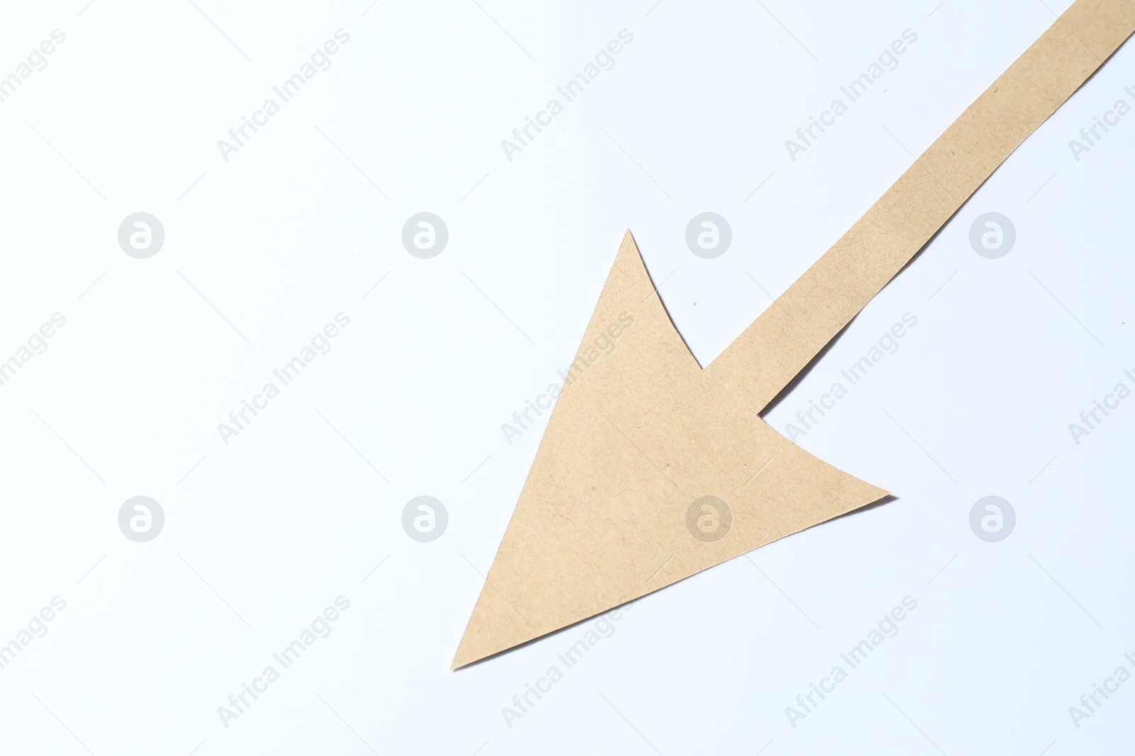 Photo of One kraft paper arrow on white background, top view. Space for text