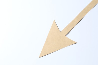 Photo of One kraft paper arrow on white background, top view. Space for text