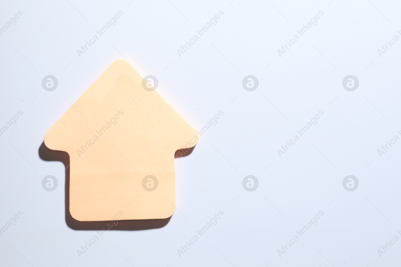 Photo of One orange paper arrow on white background, top view. Space for text