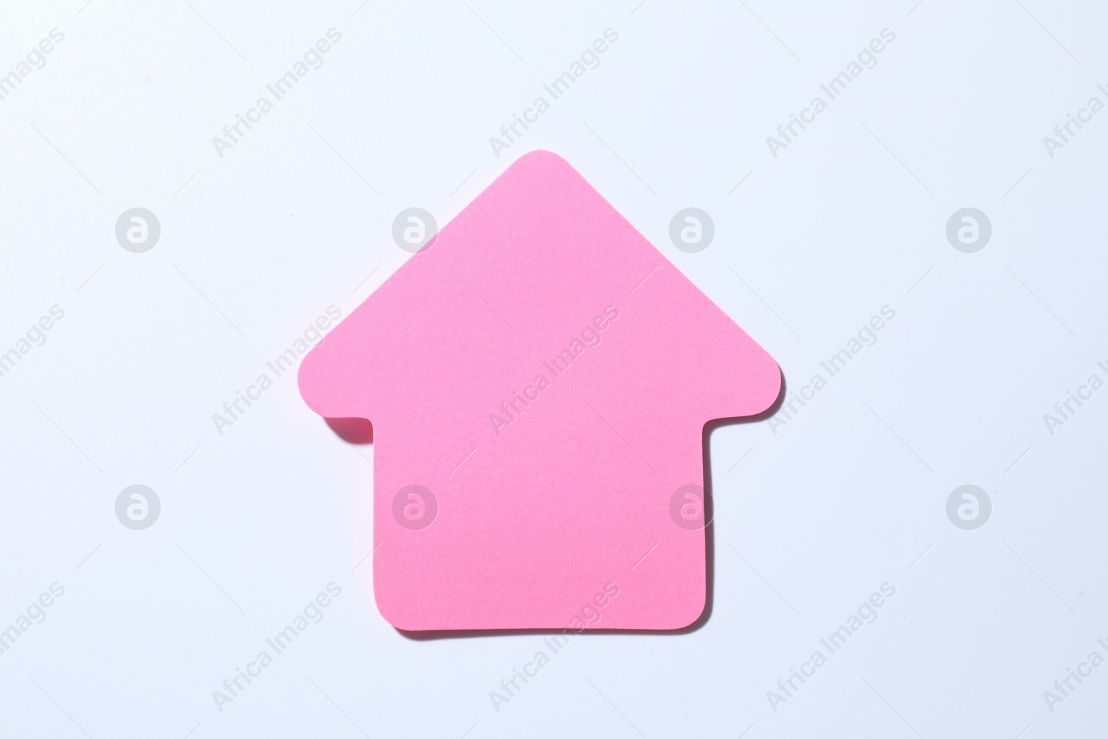 Photo of One pink paper arrow on white background, top view