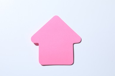 Photo of One pink paper arrow on white background, top view