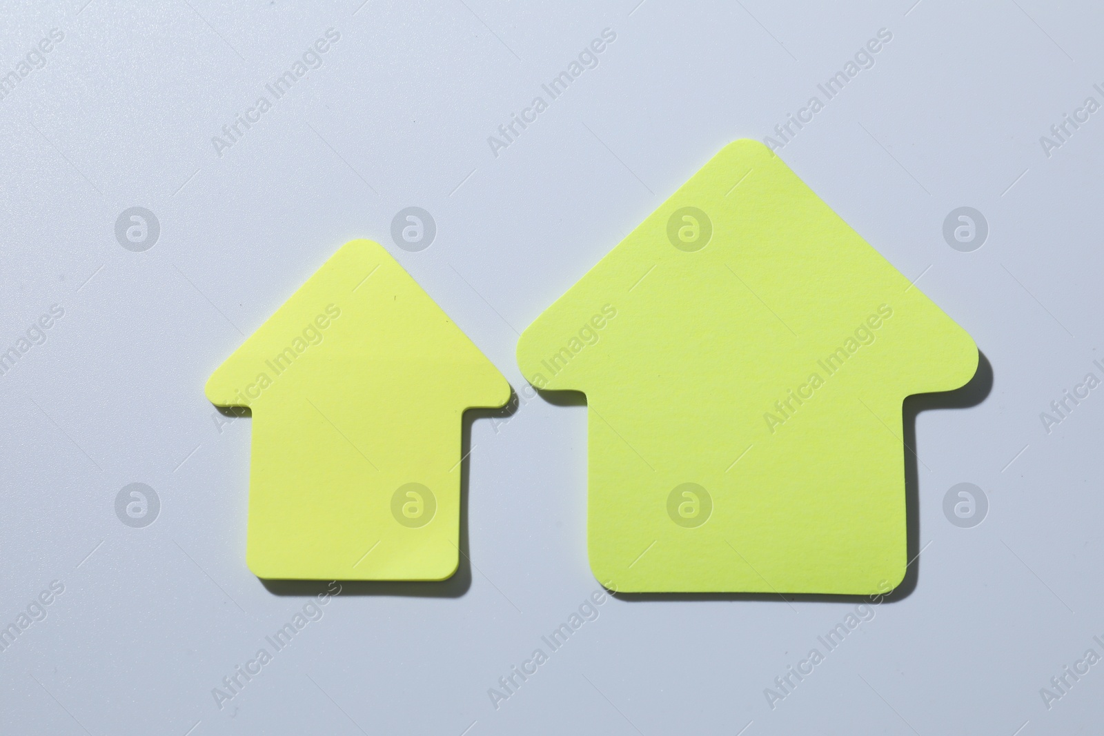 Photo of Yellow paper arrows on white background, flat lay