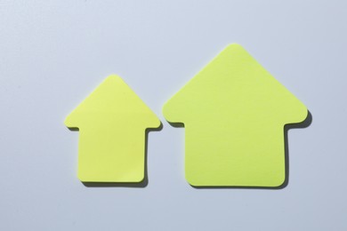 Photo of Yellow paper arrows on white background, flat lay