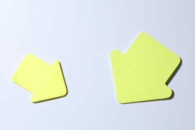 Photo of Yellow paper arrows on white background, flat lay