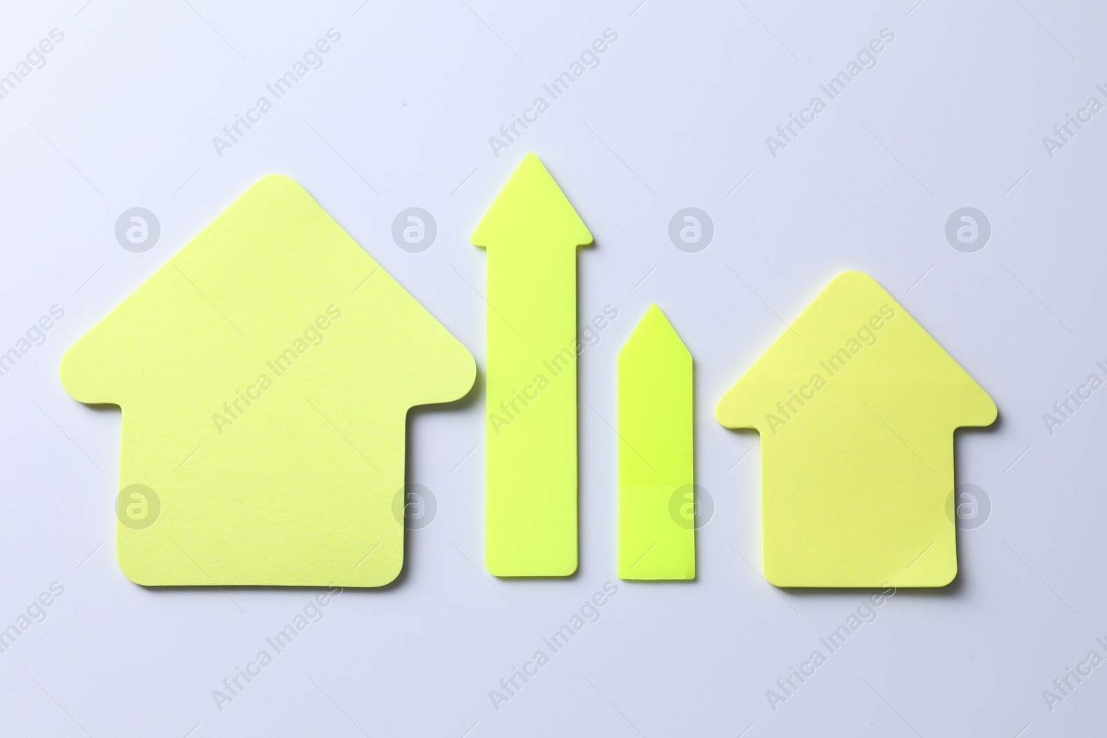 Photo of Yellow paper arrows on white background, flat lay