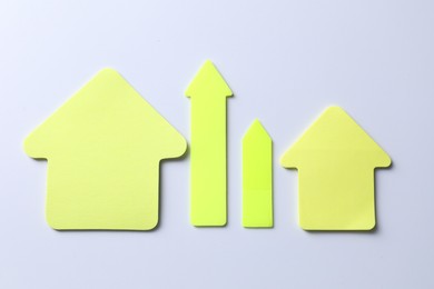 Photo of Yellow paper arrows on white background, flat lay