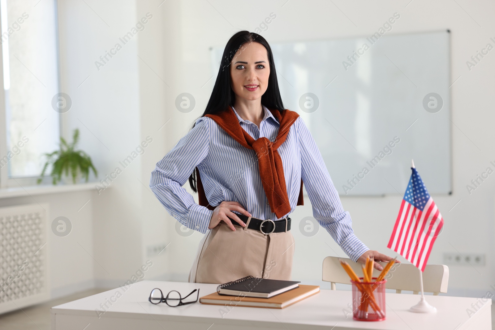 Photo of Portrait of English teacher at desk in classroom