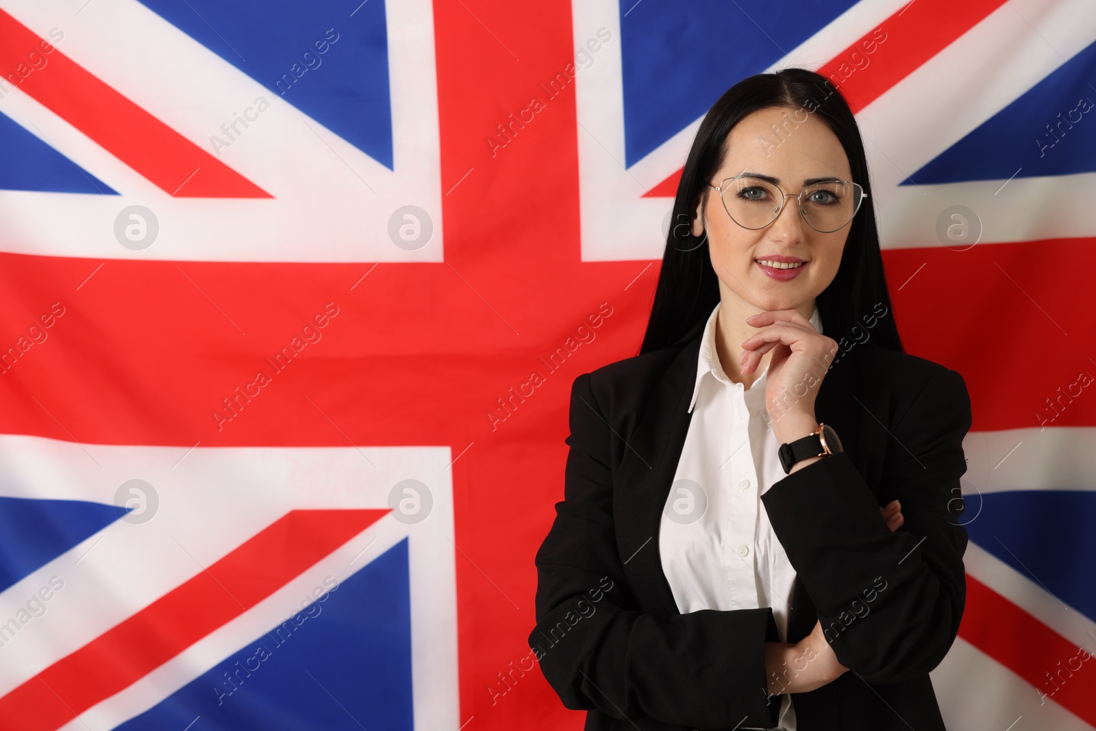 Photo of Portrait of English teacher against UK flag. Space for text