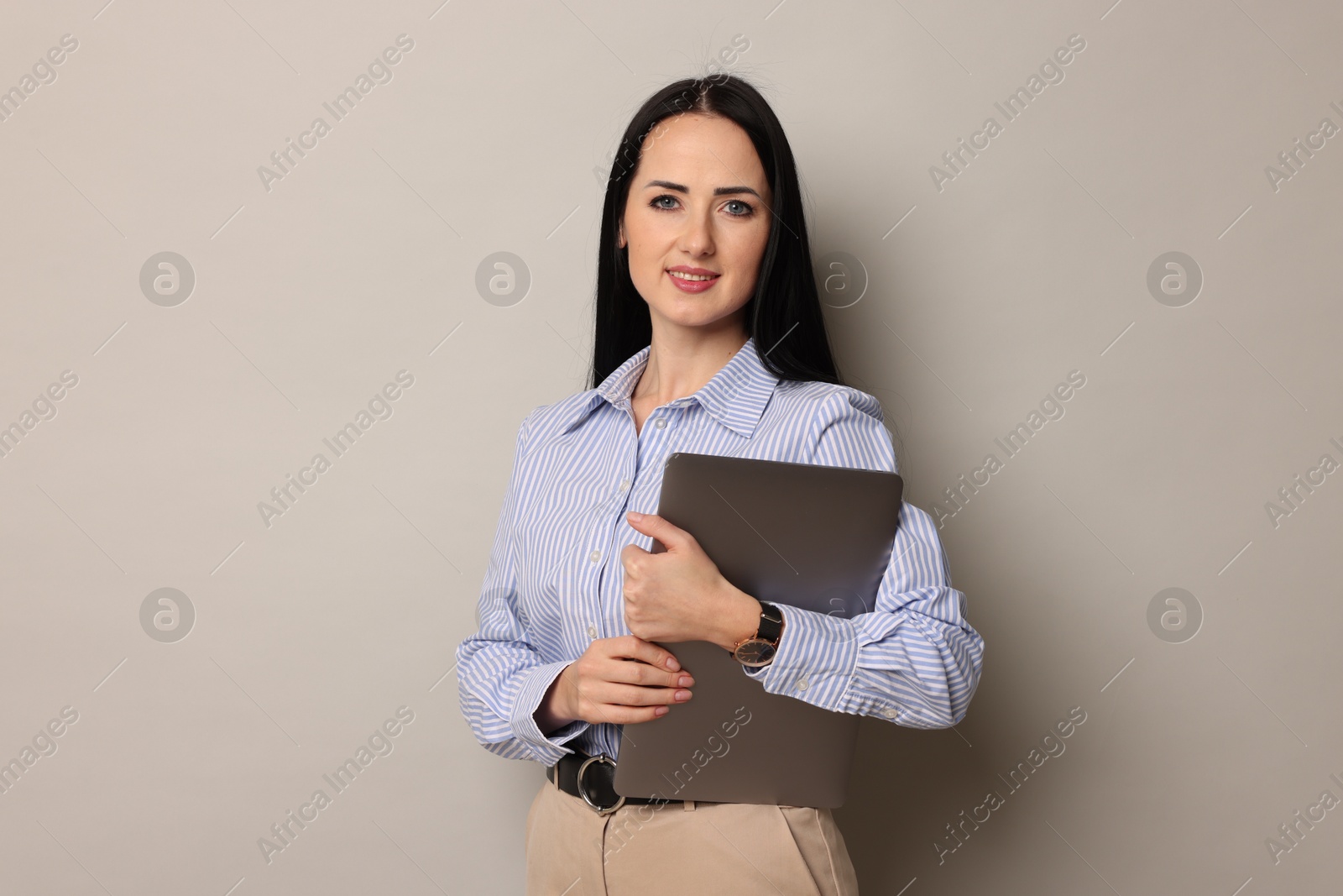 Photo of English teacher with laptop on light grey background