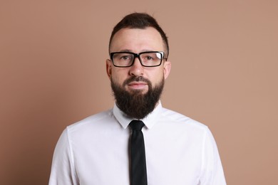 Photo of Handsome bearded man in formal outfit on brown background