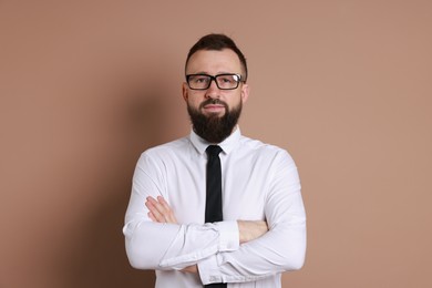 Photo of Handsome bearded man in formal outfit on brown background