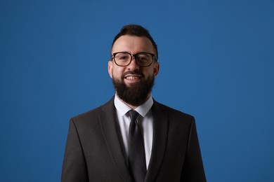 Photo of Handsome bearded man in suit on blue background