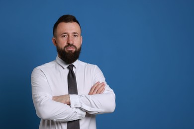 Photo of Handsome bearded man in formal outfit on blue background. Space for text