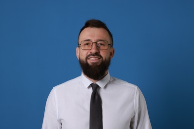 Photo of Handsome bearded man in formal outfit on blue background