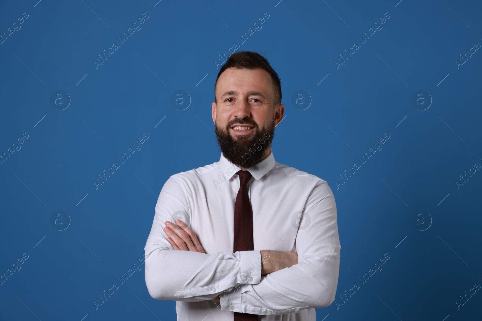 Photo of Handsome bearded man in formal outfit on blue background