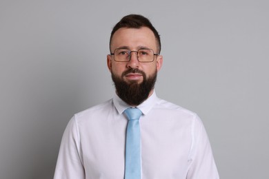 Photo of Handsome bearded man in formal outfit on grey background