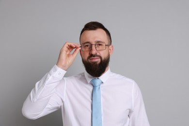 Photo of Handsome bearded man in formal outfit on grey background