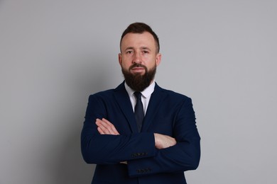 Photo of Handsome bearded man in suit on grey background