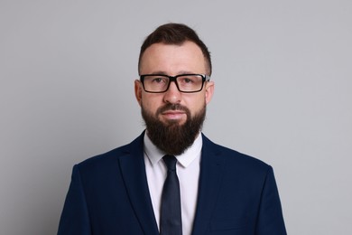 Photo of Handsome bearded man in suit on grey background