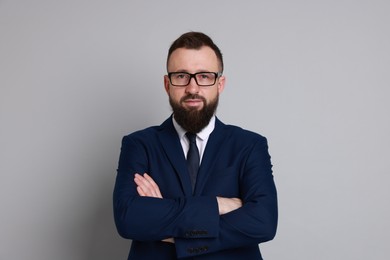 Photo of Handsome bearded man in suit on grey background