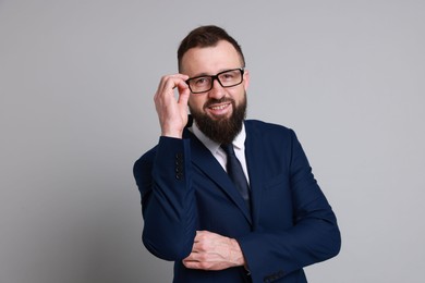 Photo of Handsome bearded man in suit on grey background