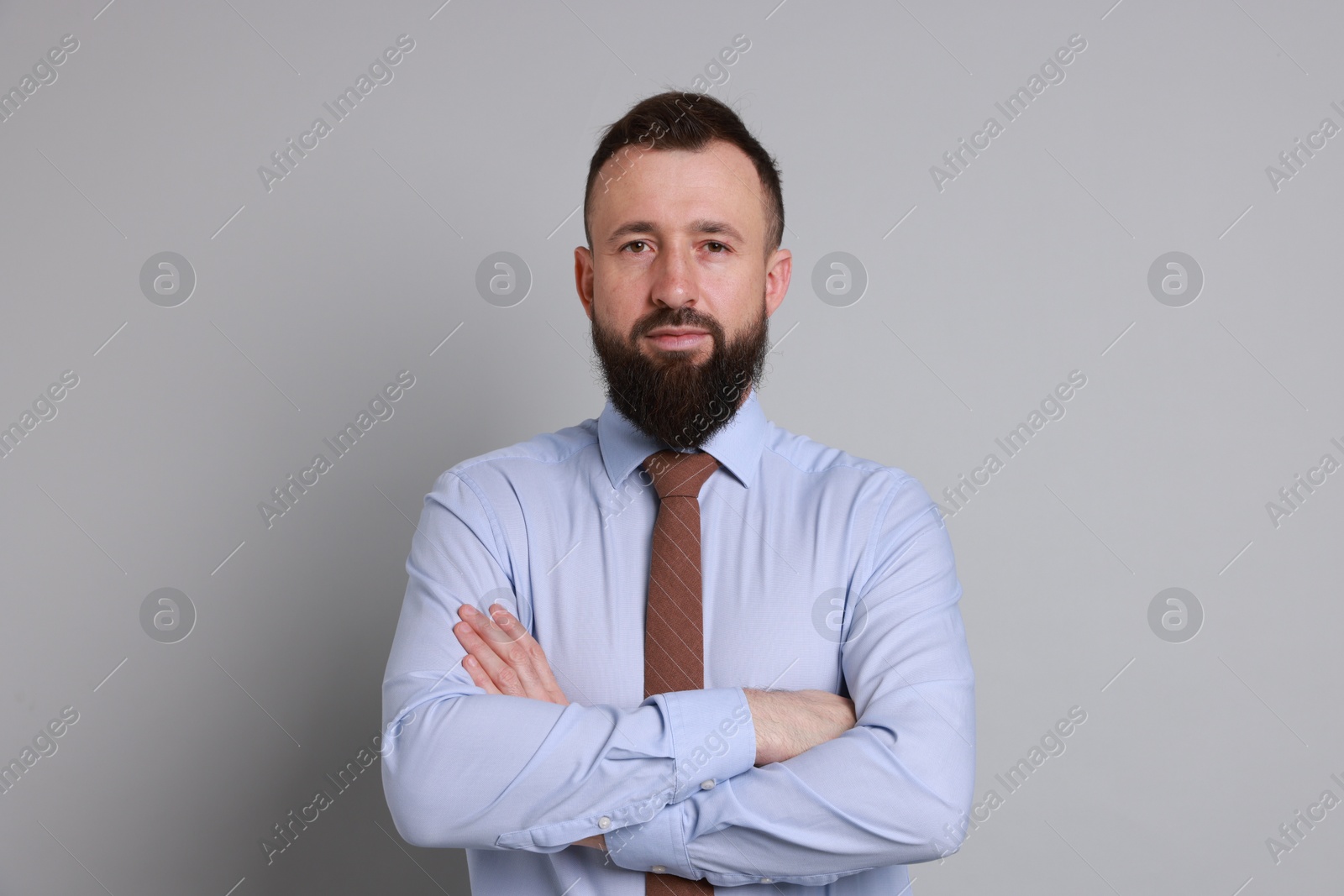 Photo of Handsome bearded man in formal outfit on grey background