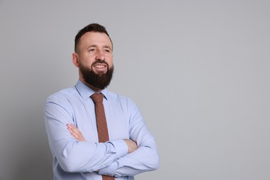 Handsome bearded man in formal outfit on grey background. Space for text