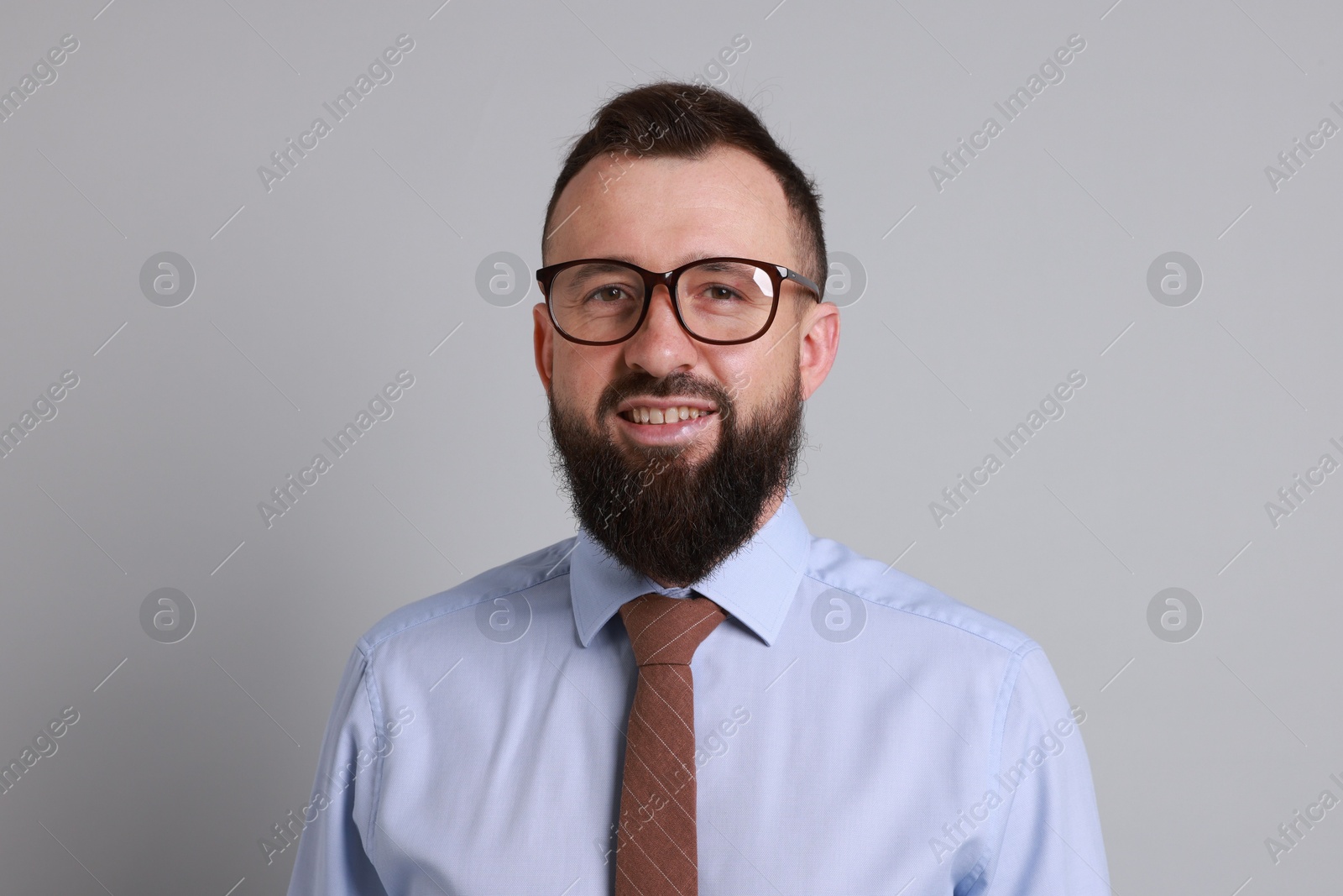 Photo of Handsome bearded man in formal outfit on grey background