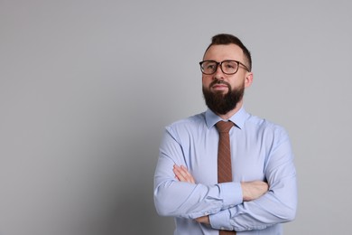 Photo of Handsome bearded man in formal outfit on grey background. Space for text