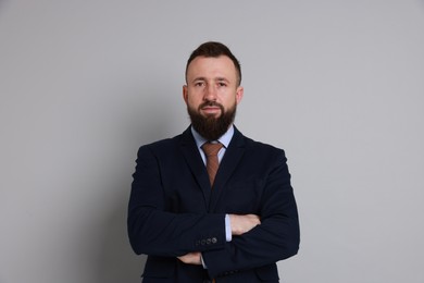 Photo of Handsome bearded man in suit on grey background