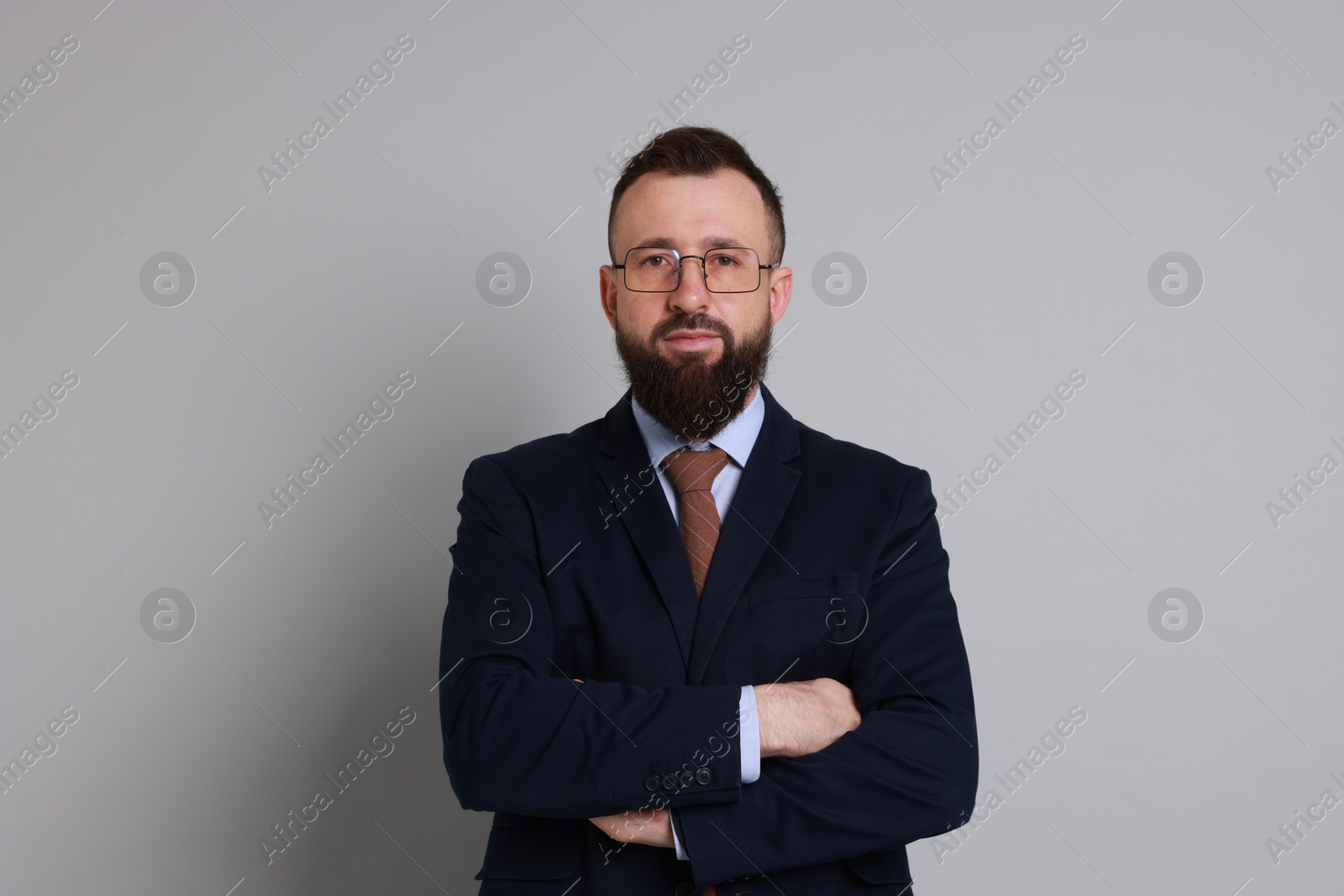 Photo of Handsome bearded man in suit on grey background