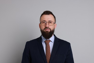 Photo of Handsome bearded man in suit on grey background