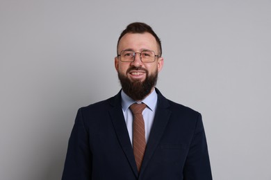 Photo of Handsome bearded man in suit on grey background