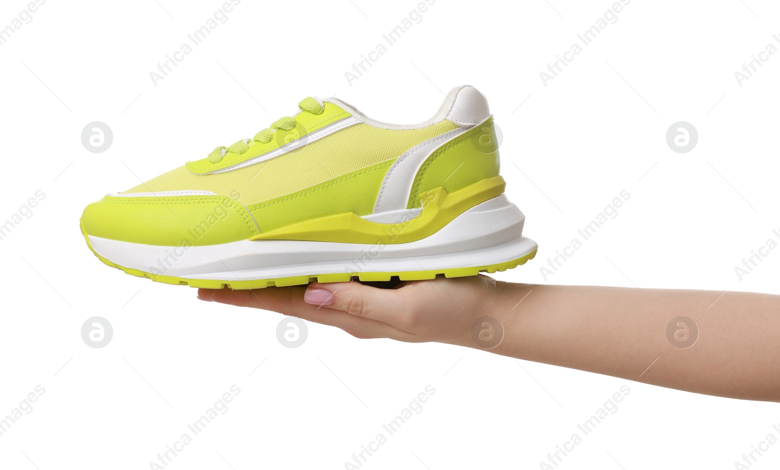 Photo of Woman with neon lime sneaker on white background, closeup