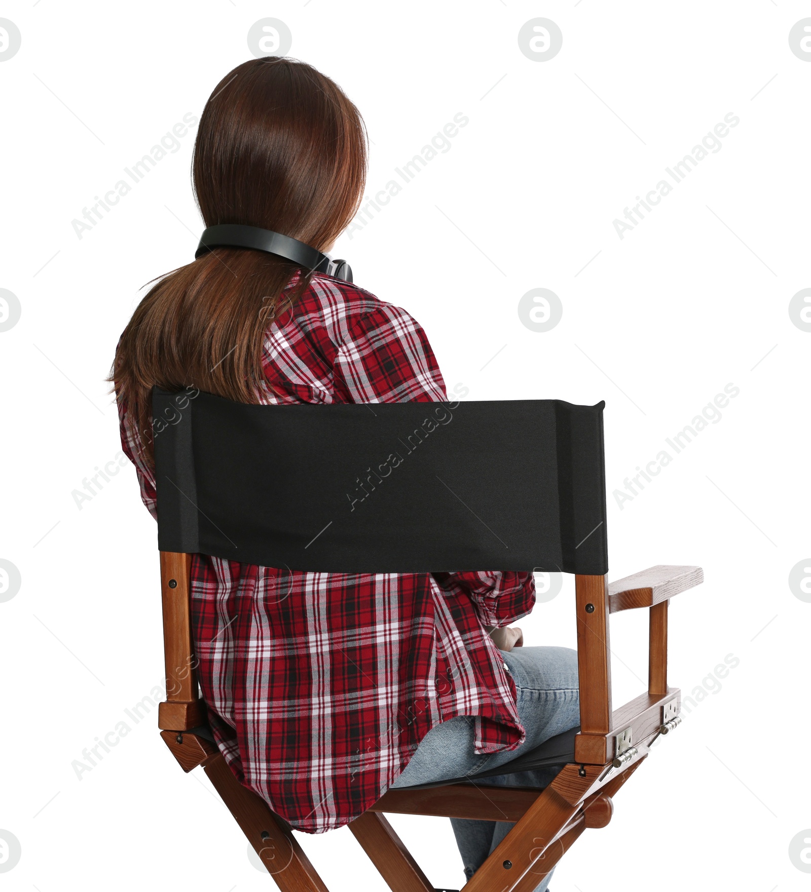 Photo of Woman sitting in director's chair on white background, back view