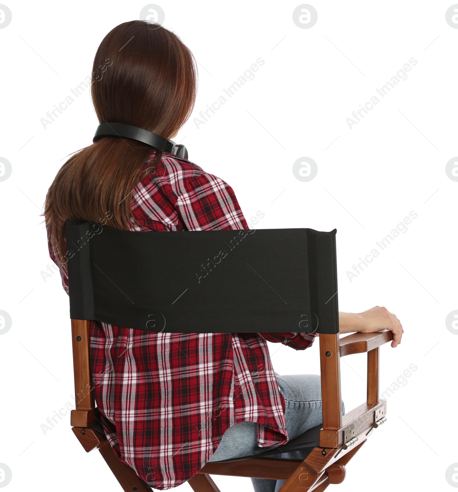 Photo of Woman sitting in director's chair on white background, back view