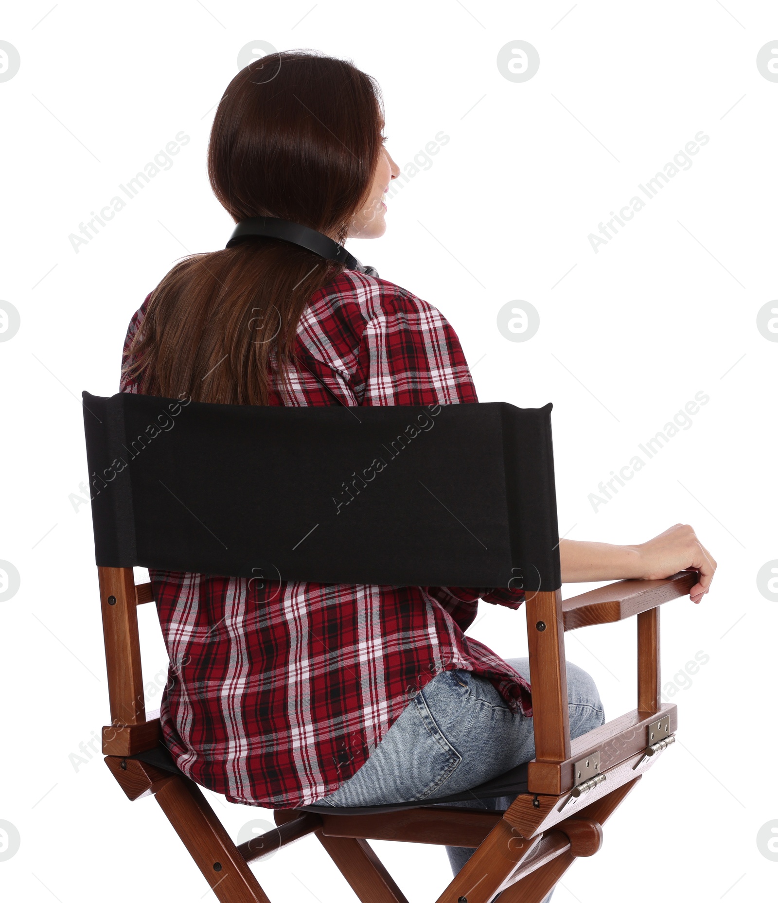 Photo of Woman sitting in director's chair on white background, back view