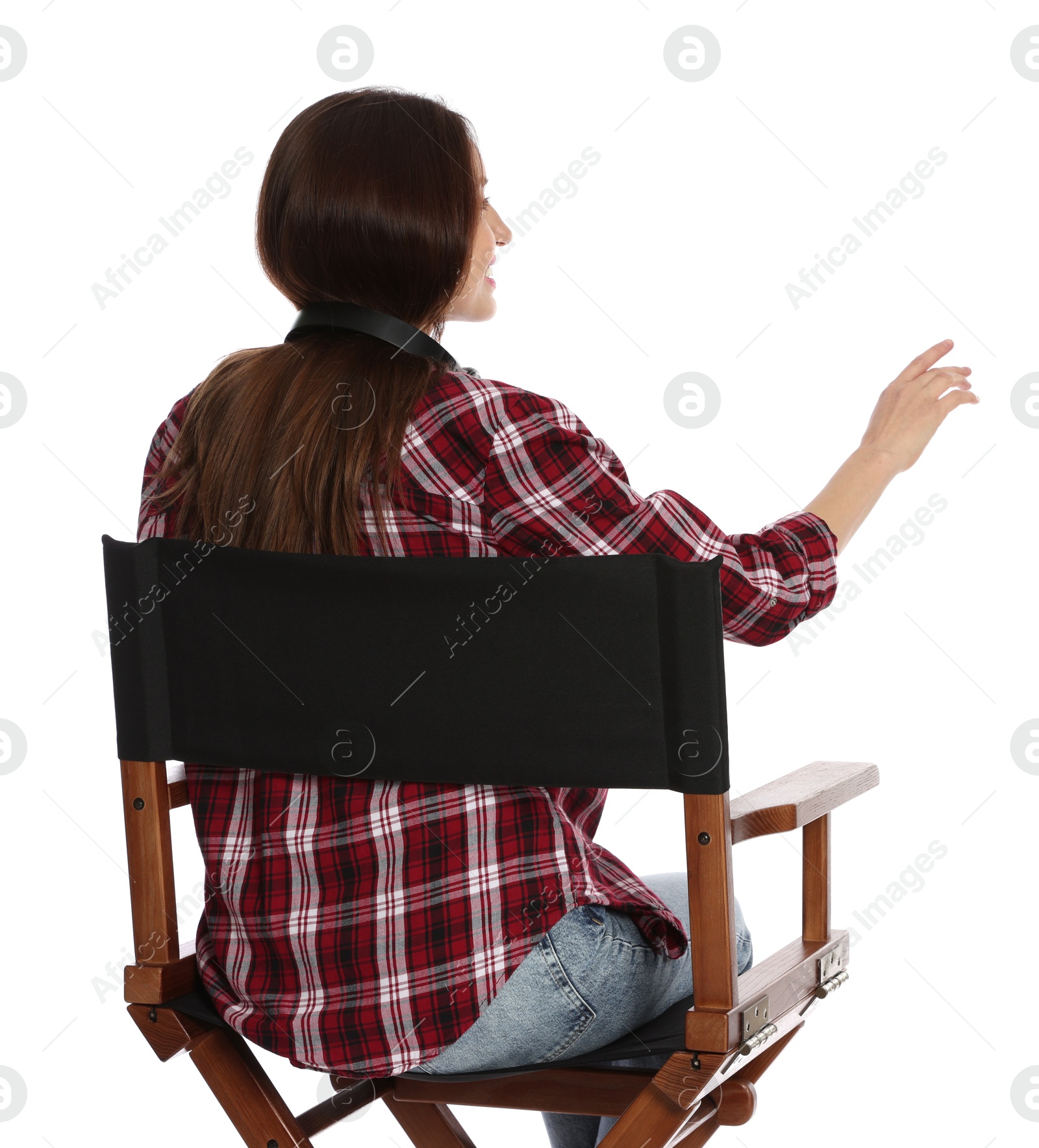 Photo of Woman sitting in director's chair on white background, back view