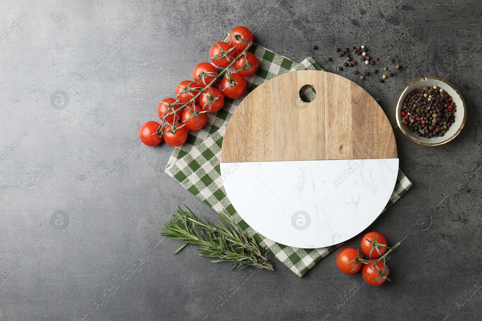 Photo of Cutting board with tomatoes and spices on grey table, flat lay. Space for text