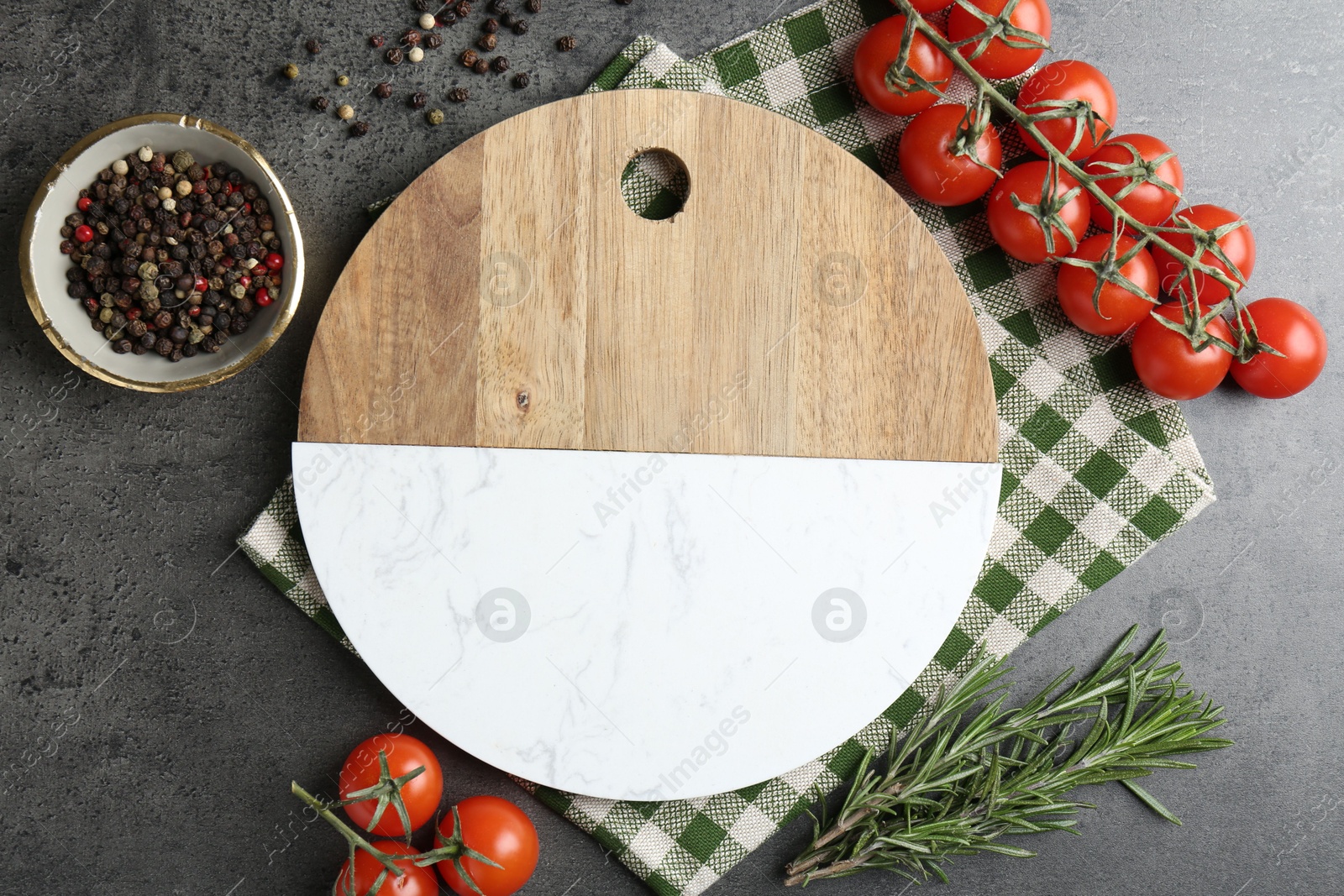 Photo of Cutting board with tomatoes and spices on grey table, flat lay