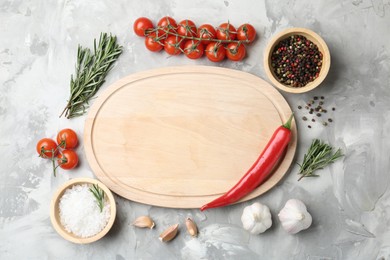 Photo of Cutting board with tomatoes and spices on grey textured table, flat lay