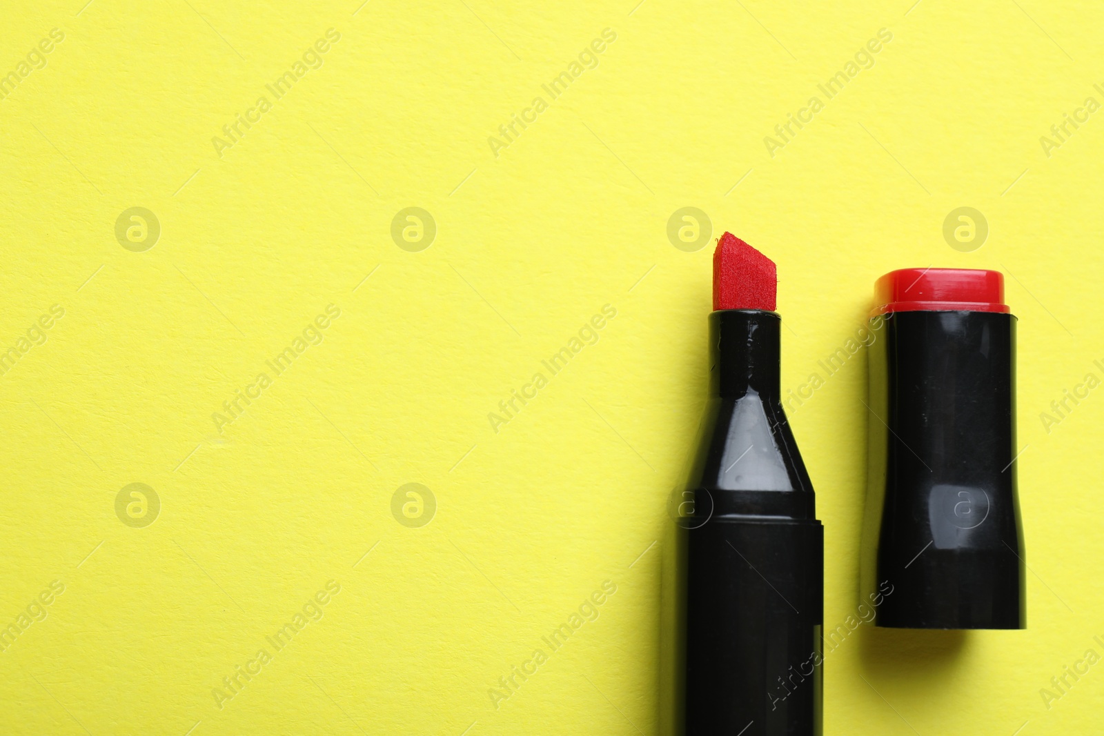 Photo of One color marker on yellow background, top view. Space for text